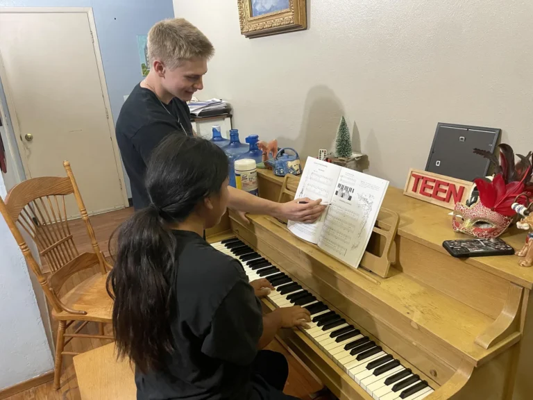 Austin Weaver teaching a piano student
